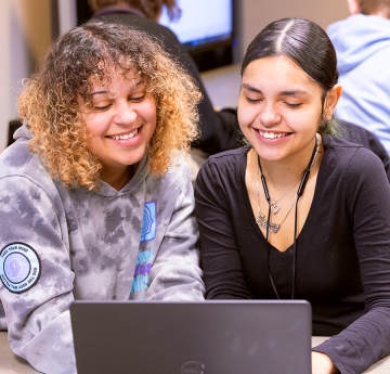 Two students sharing a laptop